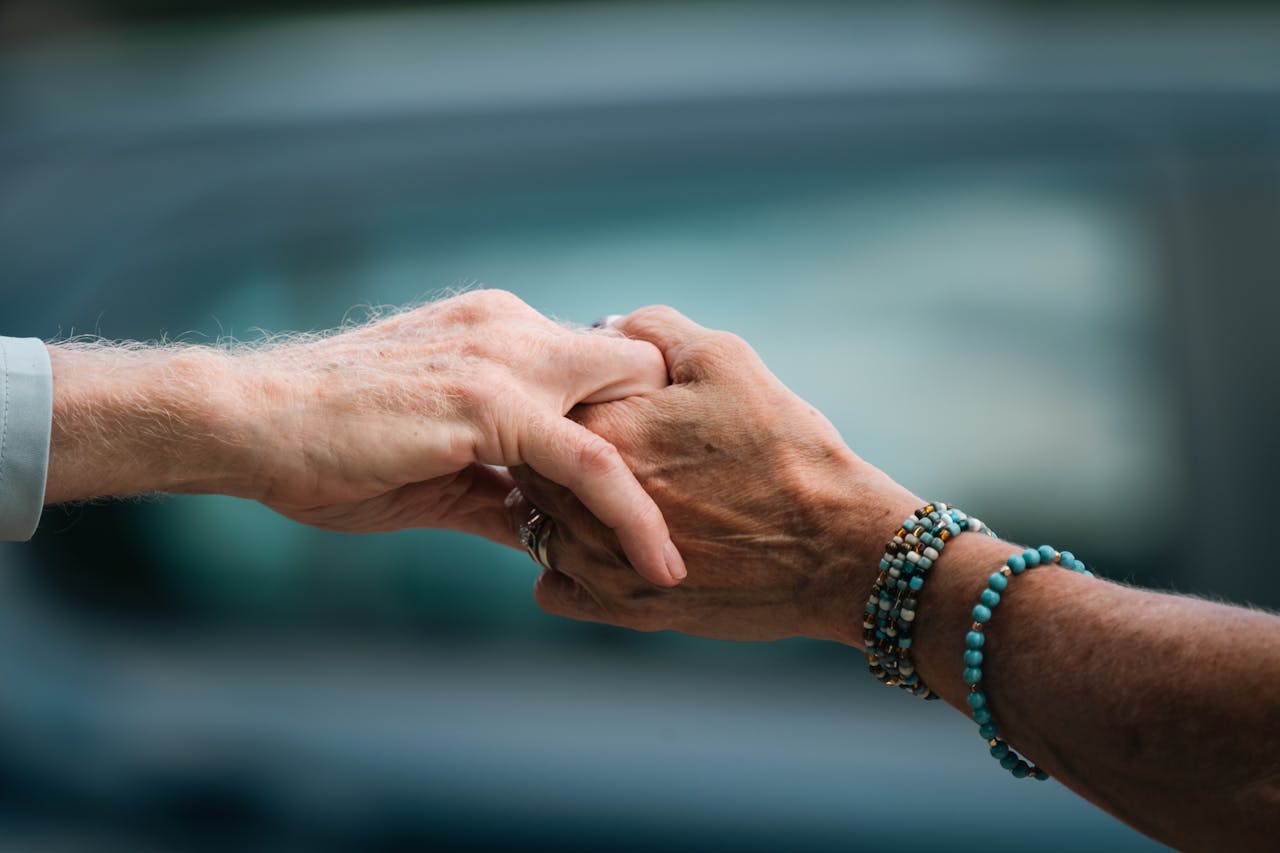 about-img A heartfelt image of two elderly individuals holding hands, symbolizing love and support.